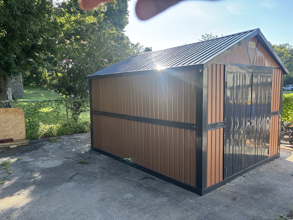 New storage shed with metal roof and wood look siding