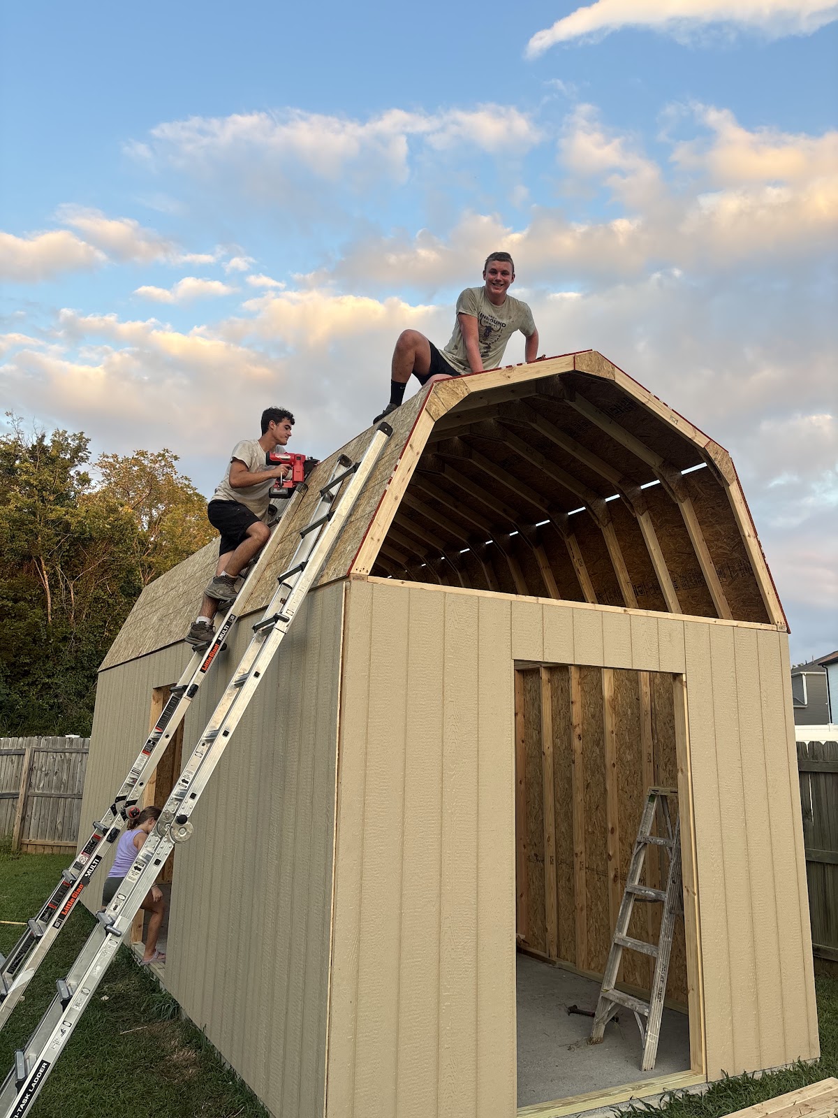 The Gasper River crew framing a new shed at sunset